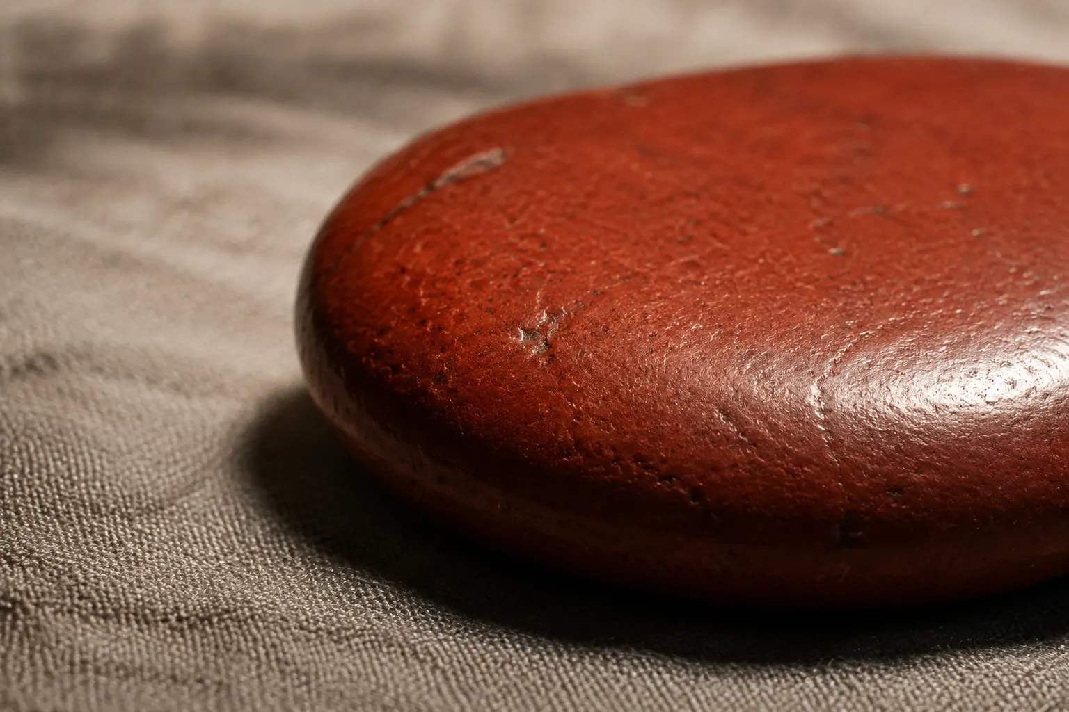 Close view of a meditation stone showing color, edge, shadow, shine, and small surface details